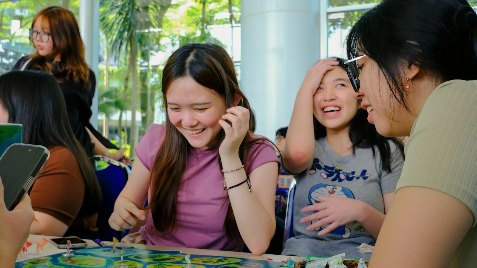 Friends laughing around a games table